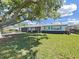 Charming single-story home with a well-manicured lawn and lovely shade tree at 7797 Barry Ct, Seminole, FL 33772