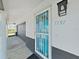 Close up of the front door area with address number, security door and door light at 7797 Barry Ct, Seminole, FL 33772