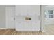 Bright kitchen with white cabinets, ample counter space and modern backsplash at 7797 Barry Ct, Seminole, FL 33772