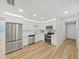 Modern white kitchen with stainless steel appliances and ample counter space at 7797 Barry Ct, Seminole, FL 33772