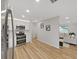 A modern kitchen boasts stainless steel appliances and leads into the living room at 7797 Barry Ct, Seminole, FL 33772