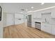The kitchen area boasts stainless steel appliances, white cabinets, and an open floorplan at 7797 Barry Ct, Seminole, FL 33772