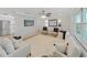 Stylish living room with a geometric accent wall, hardwood floors, and modern furniture at 7797 Barry Ct, Seminole, FL 33772