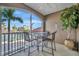 A balcony featuring a table and seating area with views of a lush waterfront community at 808 3Rd W Ave # 214, Bradenton, FL 34205