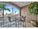 A balcony featuring a table and seating area with views of a lush waterfront community at 808 3Rd W Ave # 214, Bradenton, FL 34205