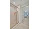 Bright bathroom features a glass shower with tile surround and views into the bedroom at 808 3Rd W Ave # 214, Bradenton, FL 34205