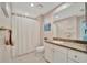 Neutral bathroom with a shower, sleek vanity, mirror, and modern fixtures at 808 3Rd W Ave # 214, Bradenton, FL 34205