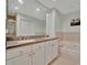 Luxurious bathroom featuring double sinks, a soaking tub, and a separate shower at 808 3Rd W Ave # 214, Bradenton, FL 34205