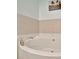 Bright bathroom featuring a pristine white bathtub with neutral tile surround and stylish fixtures at 808 3Rd W Ave # 214, Bradenton, FL 34205
