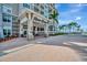 Beautiful River Dance entrance with covered drop-off, brick pavers, and professional landscaping at 808 3Rd W Ave # 214, Bradenton, FL 34205
