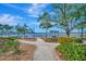 Inviting community space with walking paths, lush landscaping, and water views from relaxing covered benches at 808 3Rd W Ave # 214, Bradenton, FL 34205
