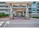 Inviting entrance to River Dance with covered portico and well-maintained landscaping at 808 3Rd W Ave # 214, Bradenton, FL 34205