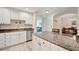 Kitchen features white cabinets, granite countertops, and stainless steel dishwasher at 808 3Rd W Ave # 214, Bradenton, FL 34205