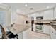 Bright kitchen features stainless steel appliances, granite countertops, and white cabinets at 808 3Rd W Ave # 214, Bradenton, FL 34205