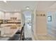 An open kitchen with granite countertops, white cabinets, stainless steel appliances and a bar overlooking the living room at 808 3Rd W Ave # 214, Bradenton, FL 34205