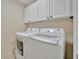 Laundry room with white washer and dryer, and white cabinets at 808 3Rd W Ave # 214, Bradenton, FL 34205