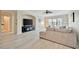 Bright living room featuring a comfortable sofa, a ceiling fan, and large windows offering ample natural light at 808 3Rd W Ave # 214, Bradenton, FL 34205