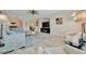 Bright living room featuring a comfortable sofa, a ceiling fan, and view to dining room at 808 3Rd W Ave # 214, Bradenton, FL 34205