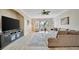 Spacious living room with a ceiling fan, couch, chairs, and lots of light at 808 3Rd W Ave # 214, Bradenton, FL 34205