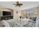 Cozy living room featuring a comfortable sofa, ceiling fan, and a large window at 808 3Rd W Ave # 214, Bradenton, FL 34205
