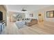 Spacious living room with a ceiling fan, couch, chairs, and lots of light at 808 3Rd W Ave # 214, Bradenton, FL 34205
