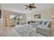 Inviting living room featuring a comfortable sofa, a ceiling fan, and large windows at 808 3Rd W Ave # 214, Bradenton, FL 34205