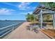 Scenic waterfront walkway featuring a covered sitting area with beautiful water views and a calming atmosphere at 808 3Rd W Ave # 214, Bradenton, FL 34205