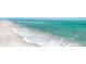 Scenic beach view with clear turquoise water and soft, white sand at 845 Benjamin Franklin Dr # 104, Sarasota, FL 34236