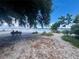 Peaceful beach scene with a bench, sparse vegetation, and calm waters at 845 Benjamin Franklin Dr # 104, Sarasota, FL 34236