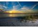 Beautiful beach at sunset with calm waters, serene sky, and natural dunes at 845 Benjamin Franklin Dr # 104, Sarasota, FL 34236