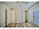 The bedroom offers wood-look flooring, ample natural light from shuttered windows, and a spacious closet at 845 Benjamin Franklin Dr # 104, Sarasota, FL 34236
