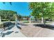 Picturesque view of St. Armands Circle park with statues, landscaping, and relaxing benches at 845 Benjamin Franklin Dr # 104, Sarasota, FL 34236