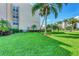 Well-maintained condo building with lush lawns and tropical landscaping at 845 Benjamin Franklin Dr # 104, Sarasota, FL 34236