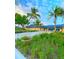 Beautiful clubhouse with a bright blue roof surrounded by greenery and palm trees at 845 Benjamin Franklin Dr # 104, Sarasota, FL 34236