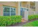 Ground-level condo with private entrance, enclosed patio space, and meticulously maintained surrounding greenery at 845 Benjamin Franklin Dr # 104, Sarasota, FL 34236