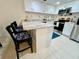 Kitchen featuring stainless steel appliances, granite counters, and breakfast bar at 845 Benjamin Franklin Dr # 104, Sarasota, FL 34236