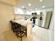 Eat-in kitchen with stainless steel appliances, granite counters, and breakfast bar seating at 845 Benjamin Franklin Dr # 104, Sarasota, FL 34236