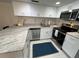 Updated kitchen with stainless steel appliances, granite counters, and tiled flooring at 845 Benjamin Franklin Dr # 104, Sarasota, FL 34236