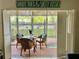 Enclosed lanai with brick flooring and wicker furniture at 845 Benjamin Franklin Dr # 104, Sarasota, FL 34236
