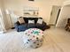 Relaxing living room with comfortable sofa, ottoman, and beach-themed decor, perfect for coastal living at 845 Benjamin Franklin Dr # 104, Sarasota, FL 34236