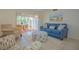 The comfortably furnished living room includes a couch and chairs, with patio access bringing in natural light at 845 Benjamin Franklin Dr # 104, Sarasota, FL 34236