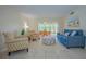 Comfortable living room with access to outdoor seating and plenty of natural light at 845 Benjamin Franklin Dr # 104, Sarasota, FL 34236