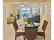 The living space features bright, open areas including the living room and dining area with an outdoor view at 845 Benjamin Franklin Dr # 104, Sarasota, FL 34236