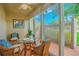 A charming outdoor seating area with wicker chairs and a glass table offers a cozy space to enjoy the scenery at 845 Benjamin Franklin Dr # 104, Sarasota, FL 34236