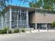Modern park building featuring concrete and wood construction, surrounded by lush greenery, and white gravel ground at 845 Benjamin Franklin Dr # 104, Sarasota, FL 34236