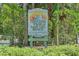 Ted Sperling Park at South Lido Beach sign, surrounded by lush greenery and natural beauty at 845 Benjamin Franklin Dr # 104, Sarasota, FL 34236