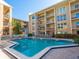Community pool with plenty of lounge chairs in a bright and sunny setting at 845 Benjamin Franklin Dr # 104, Sarasota, FL 34236