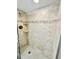 The updated shower features stylish tiling, recessed shelving, and modern fixtures for a spa-like experience at 845 Benjamin Franklin Dr # 104, Sarasota, FL 34236