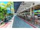 Outdoor patio seating with shade canopies alongside a commercial building at 845 Benjamin Franklin Dr # 104, Sarasota, FL 34236
