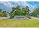 Elegant St. Armands Key entrance sign surrounded by lush landscaping and manicured lawns at 845 Benjamin Franklin Dr # 104, Sarasota, FL 34236